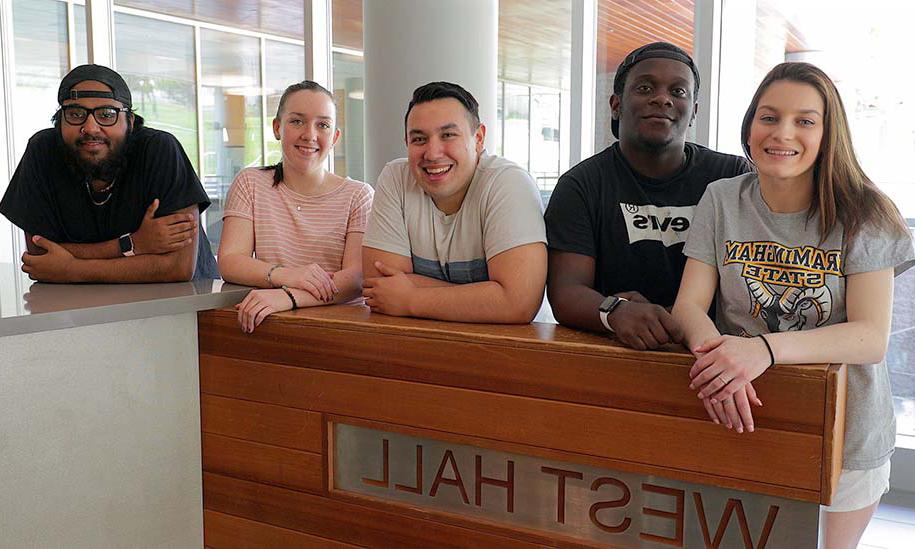 Five FSU students standing in front of West Hall sign